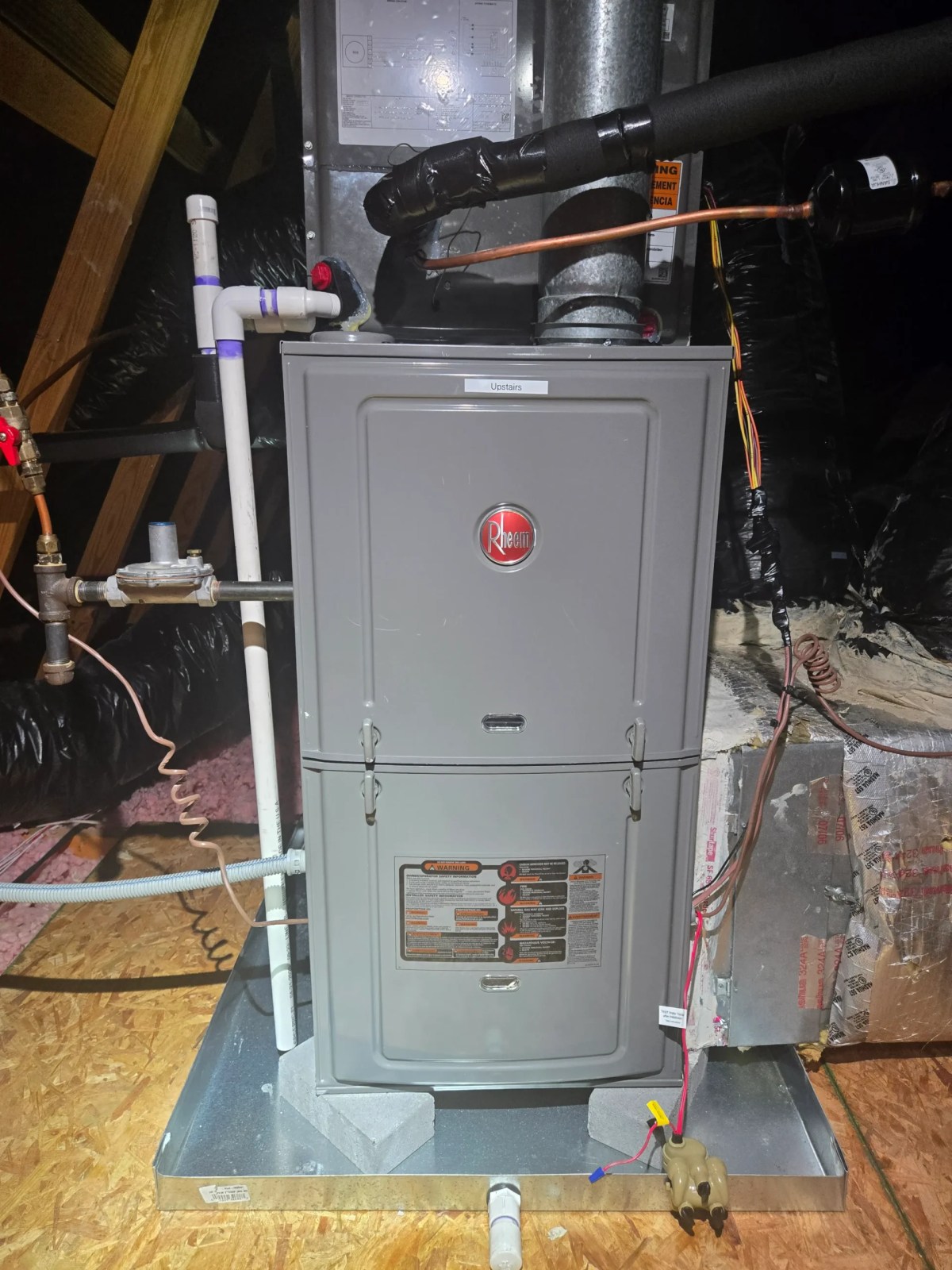 New Rheem gas furnace installed in a residential attic during a professional heating system replacement.