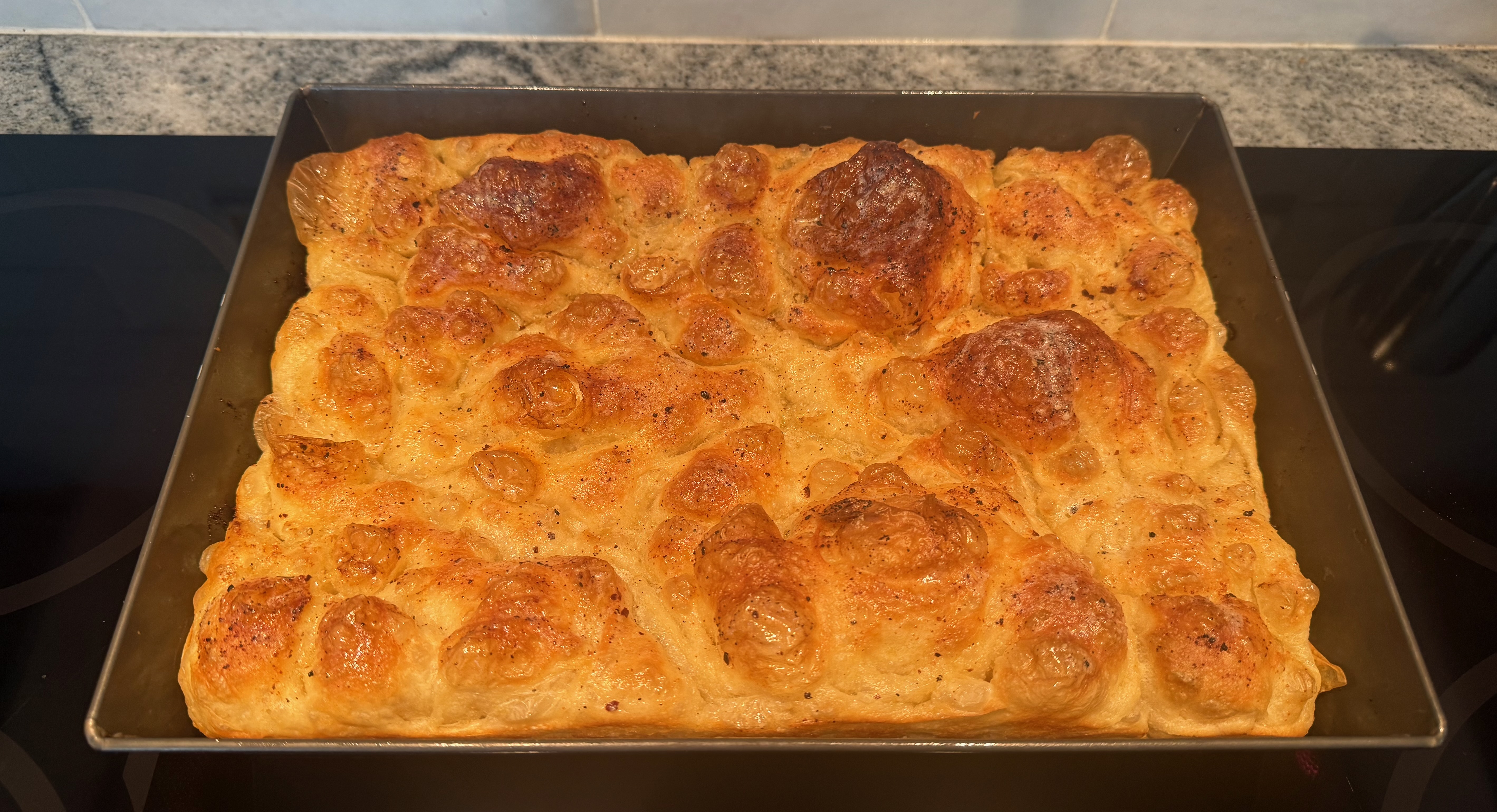 Golden focaccia just out of the oven, baked at home