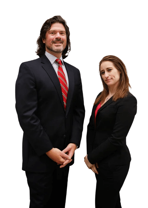 Professional attorneys Aaron Shapiro and Amanda Shaffer standing confidently, dressed in business suits, representing The Shapiro Law Firm, specializing in immigration and family law services in New York.