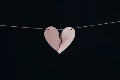 Broken heart hanging on a string, symbolizing divorce and emotional challenges in family law.