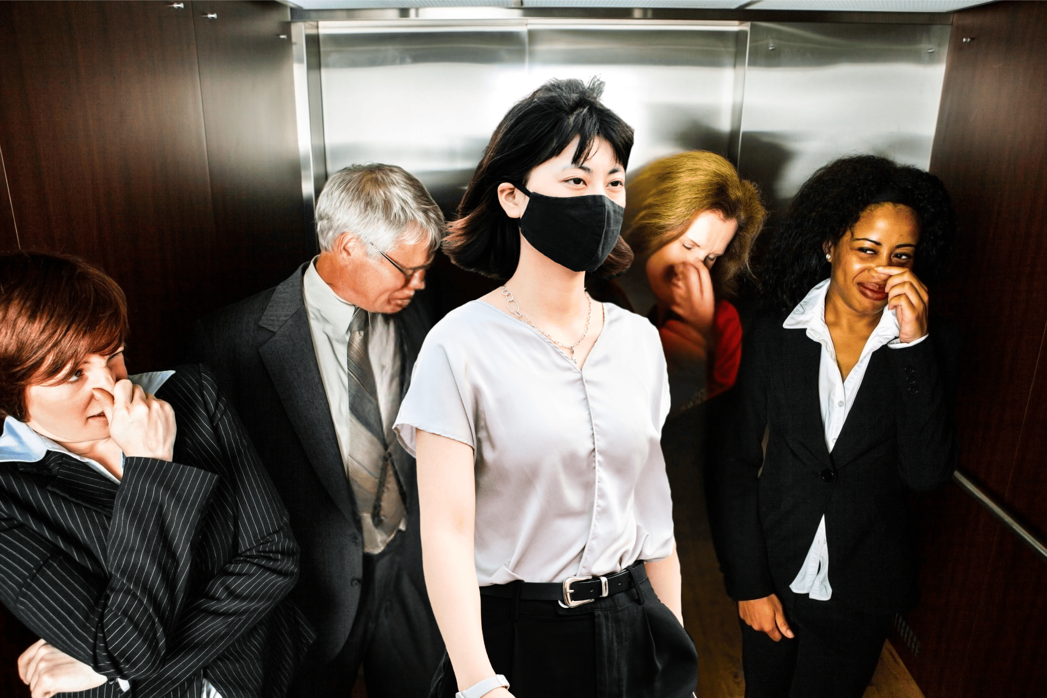 a woman masks while others hold their nose in an elevator