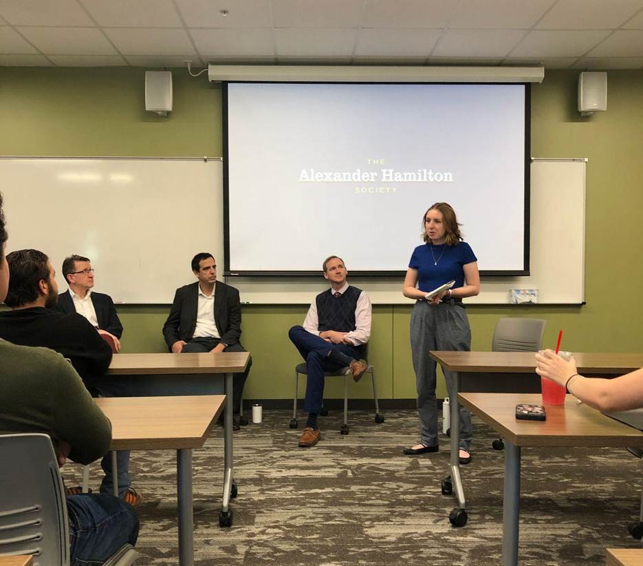 Miller moderates a panel of professors at an AHS event