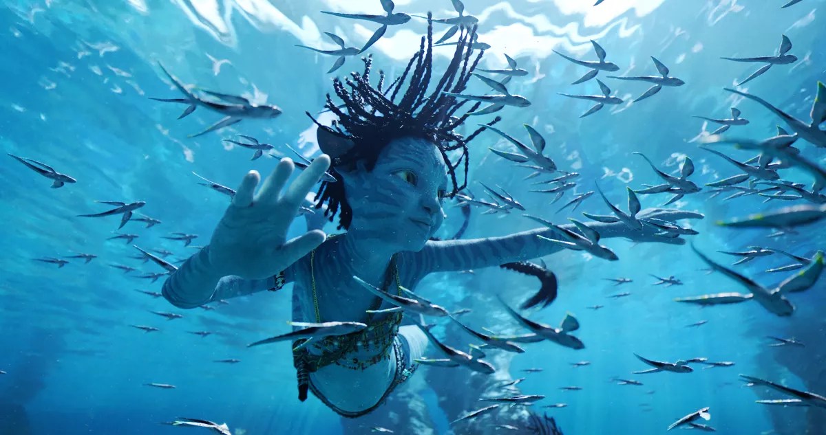 A still from the 2022 Avatar film showing a character underwater surrounded by fish