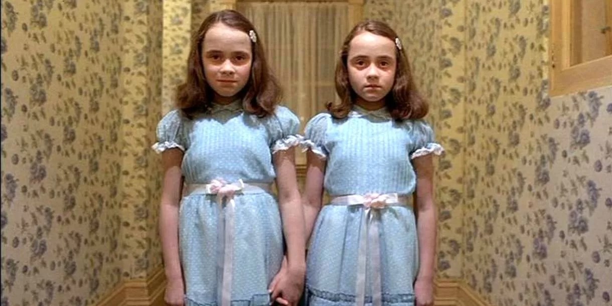 A movie still of the twins from The Shining