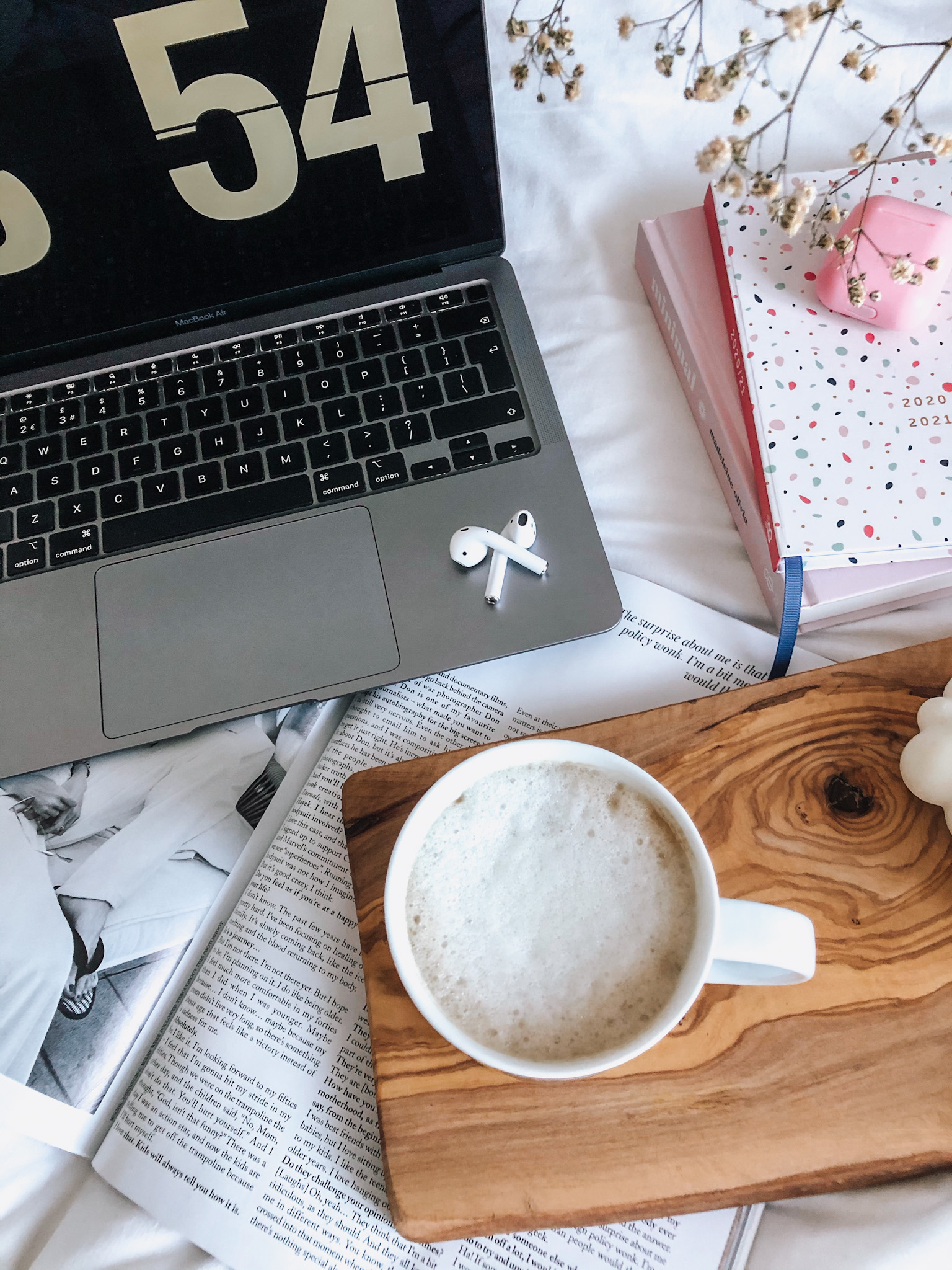 Macbook, Airpods and a cup of coffee.
