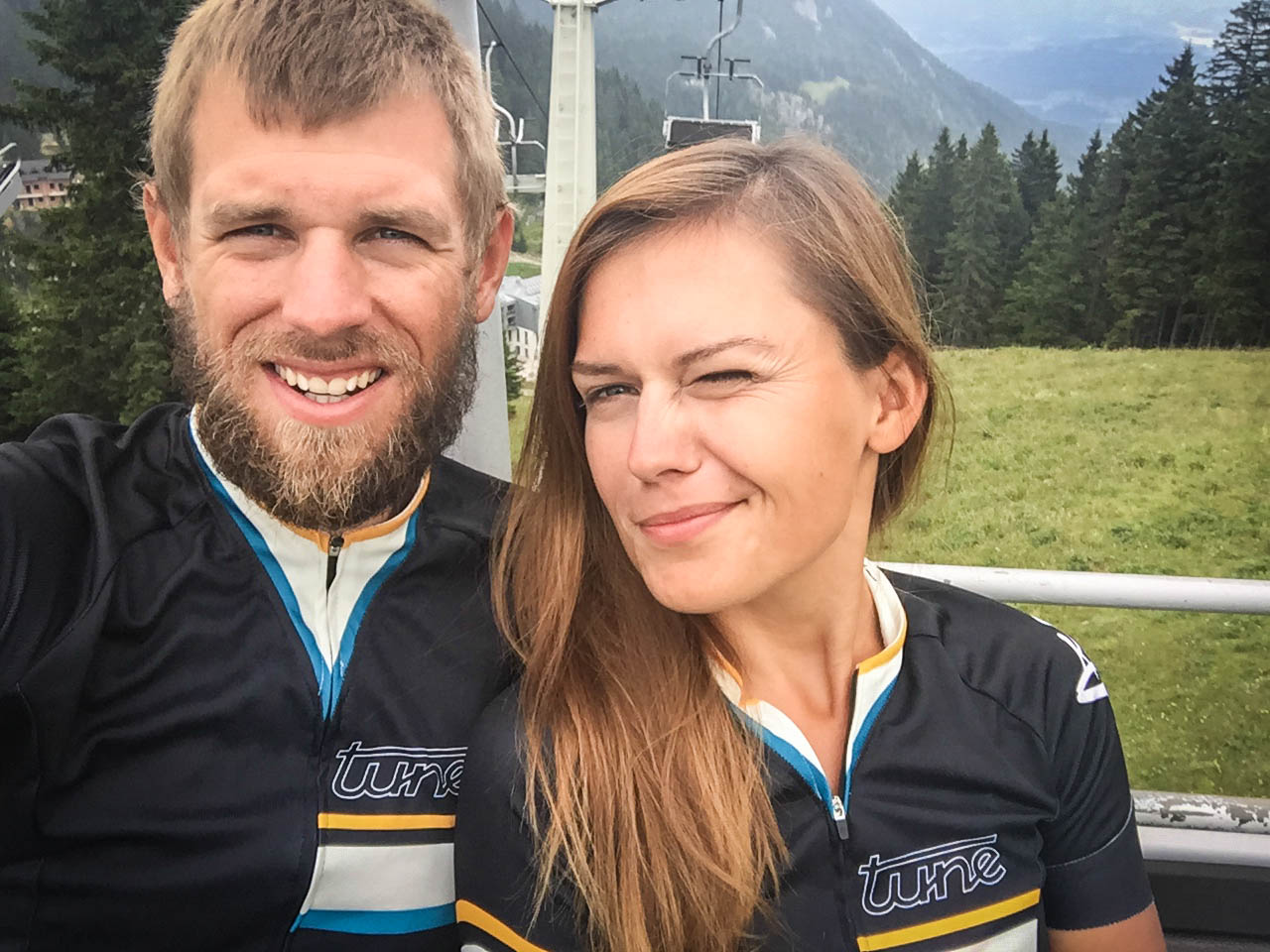 man and women in bicycle jerseys on a cable car