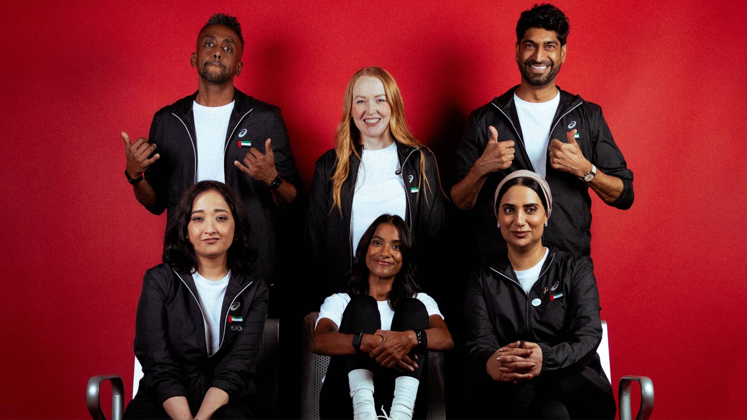 Six UAE transplant athletes pose proudly in ASICS gear.