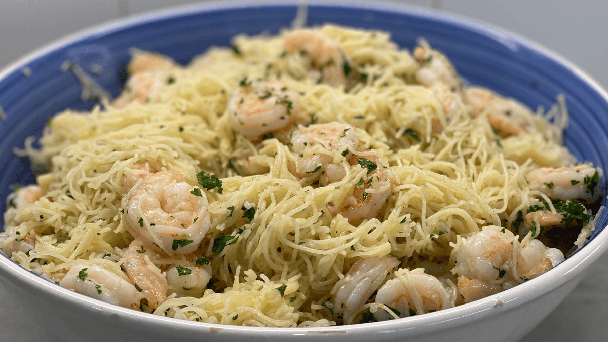 Shrimp Scampi tossed with freshly grated cheese in handmade Italian bowl