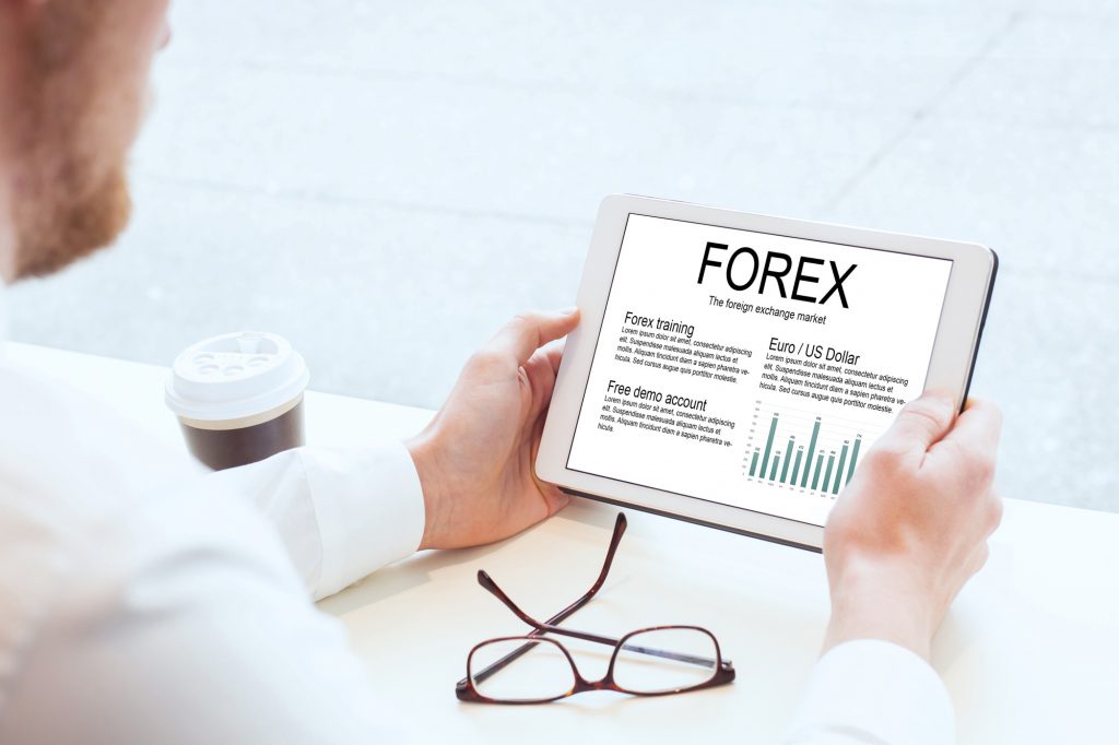 forex, businessman reading about foreign exchange market on tablet