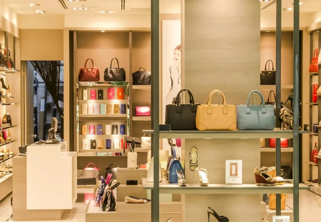 shelf in a store with shoes and handbags