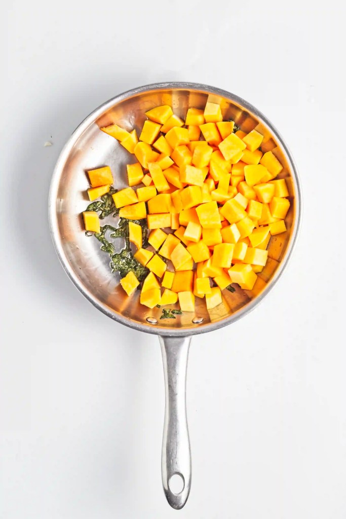 butternut squash and sage cooking in a pan