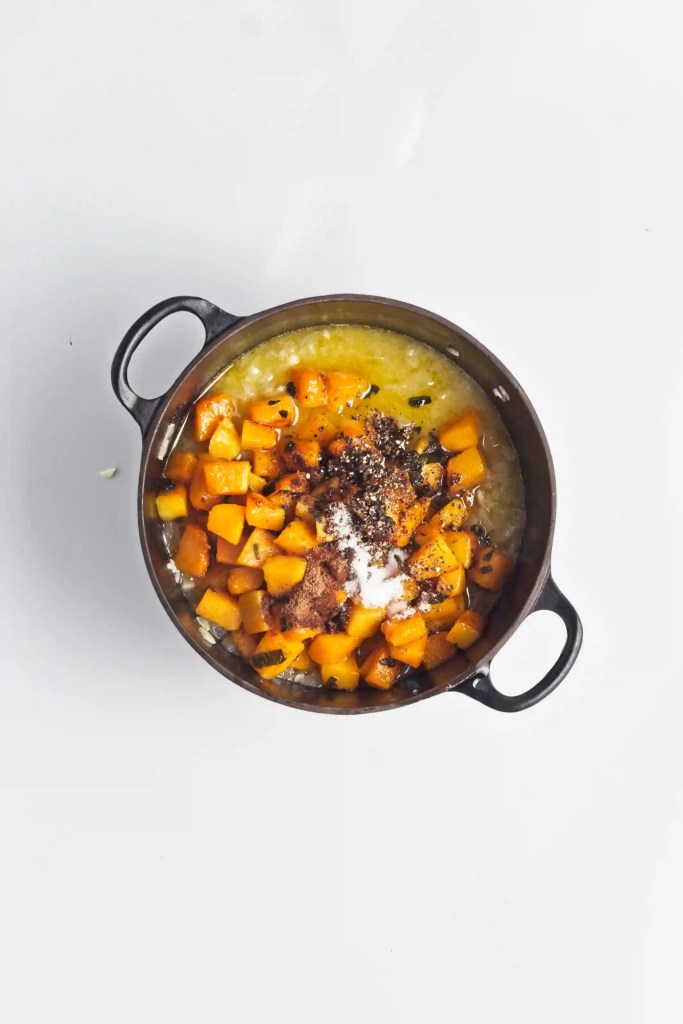 butternut squash, sage, and spices added to the pot of rice