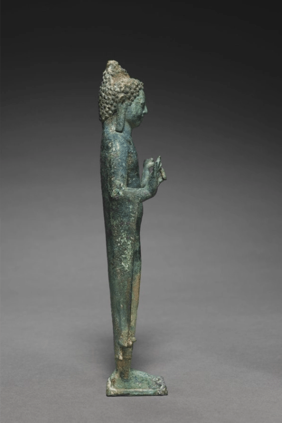 Teaching Buddha sculpture, side view showing seated posture and drapery

