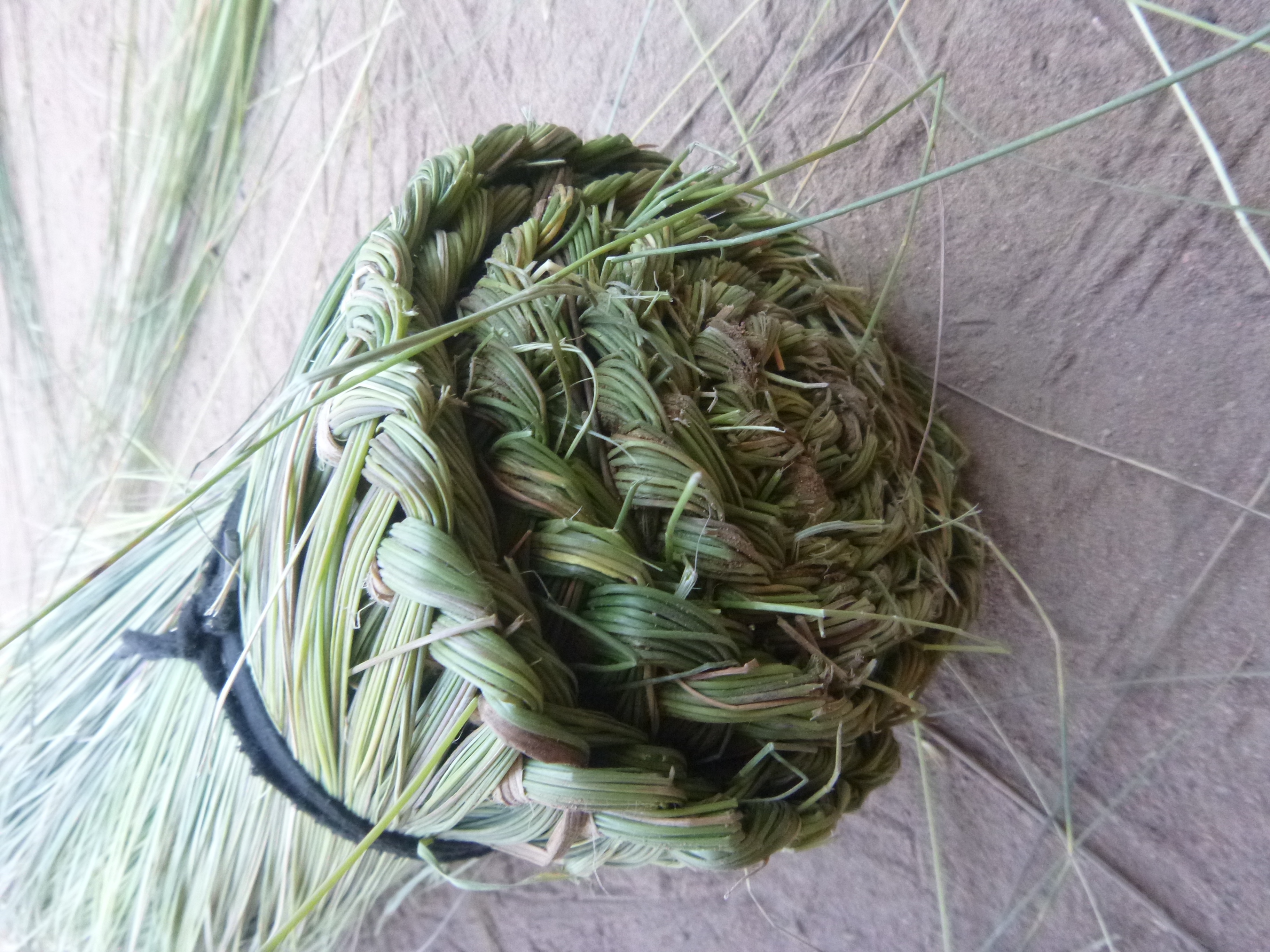 Finished broom made from wetland grasses.