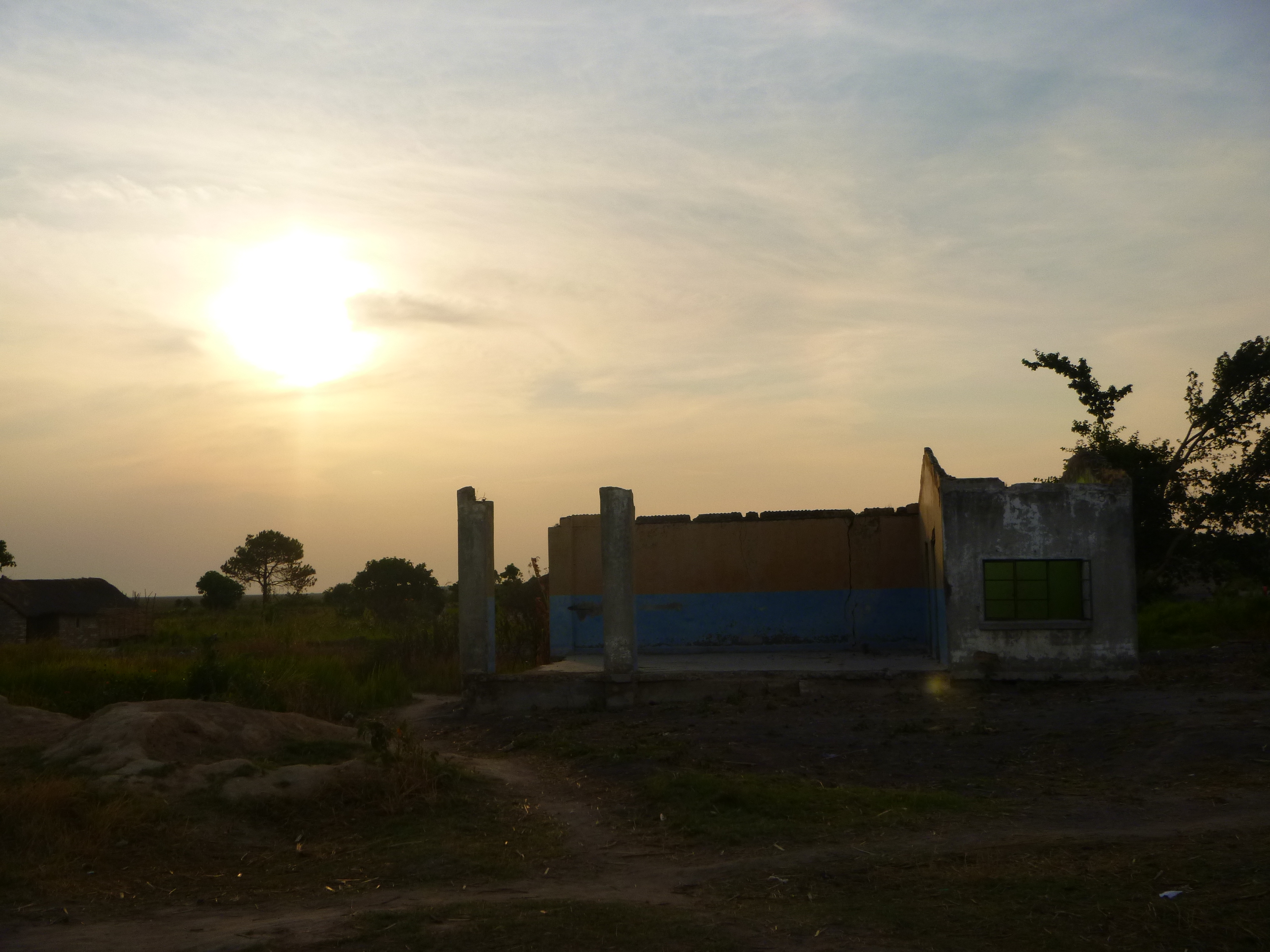 Sunset behind an abandoned building in the village of Nsombo.