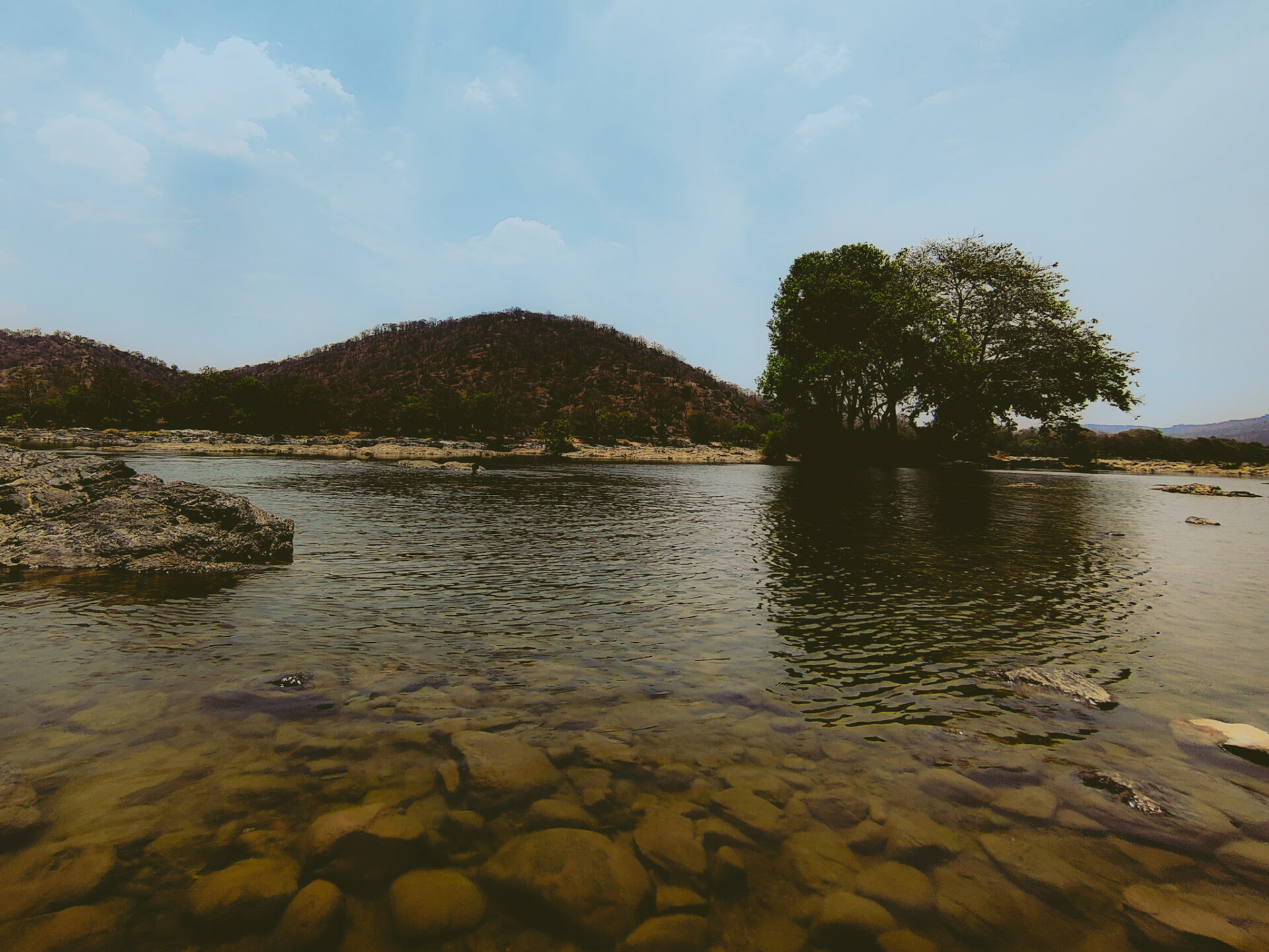 Sangam with a view of water, rocks and hills