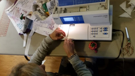 11b. The edging and the quilt are carefully joined, first with fabric glue and then with thread on the machine.