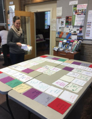 3. Your square is then arranged with 63 others into a pattern. Each of the rows is condensed into a pile, numbered for placement, and then brought to a stitcher.