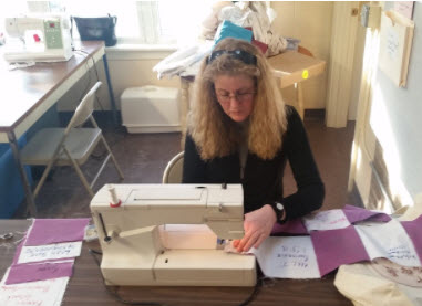 6. Once ironed, the rows are stitched together to create the raw quilt top.