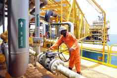 A worker inspect facilities on an upstre A worker inspect facilities on an upstream oil drilling platform at the Total oil platform at Amenem, 35 kilometers away from Port Harcourt in the Niger Delta. Amenem is the hub of Total oil production with two oil well producing over 100,000 barrels of crude daily. AFP PHOTO / PIUS UTOMI EKPEI (Photo credit should read PIUS UTOMI EKPEI/AFP/Getty Images)
