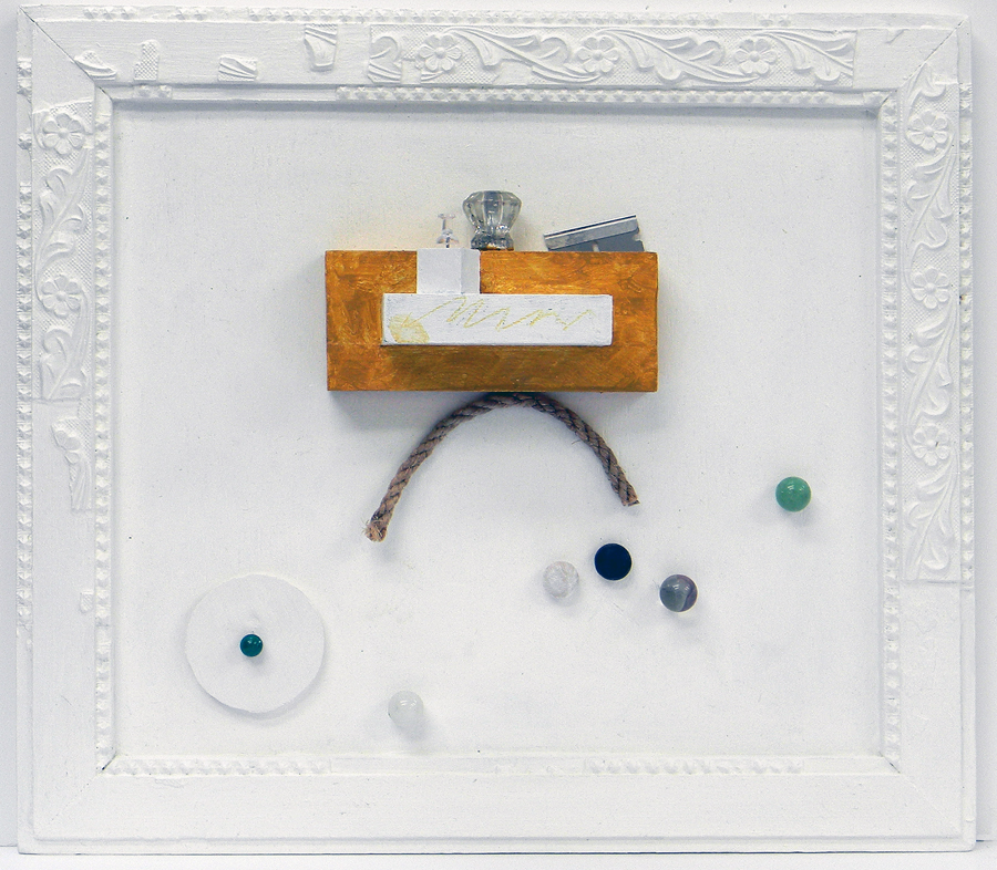 Block of wood, razor blade, marble, rope, pushpin,crystal handle and several wooden tabs.