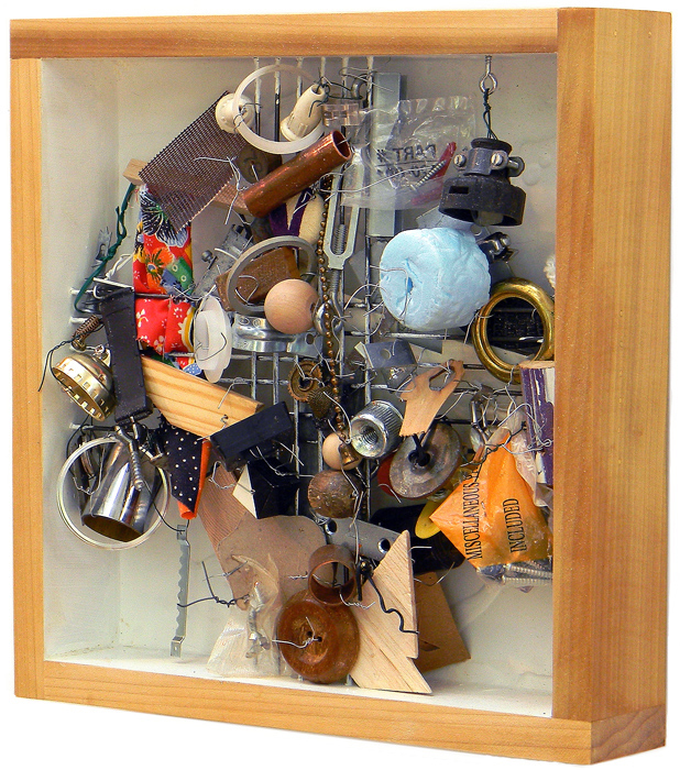 Wood box with lots of stuff stuffed inside on 12 steel rods. 12"x12"x3"