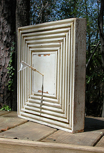 Painted wood with white cloth on a stick. 12"x12"x6".