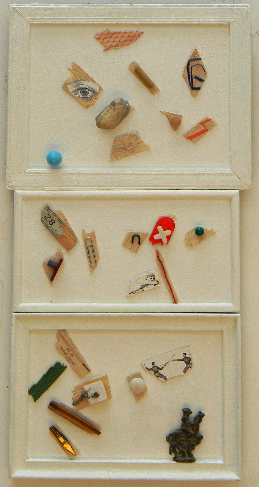 Three frames with things attached to boards. Overall 19 inches x 9.5 inches.