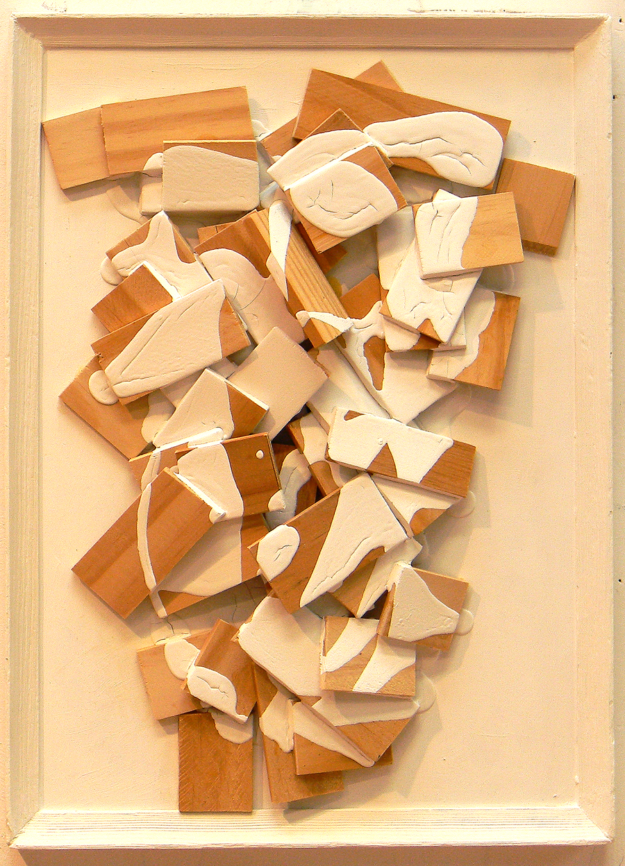 Construction. Wood chips glued to a board in a frame 17 inches x 12 inches with white paint applied.