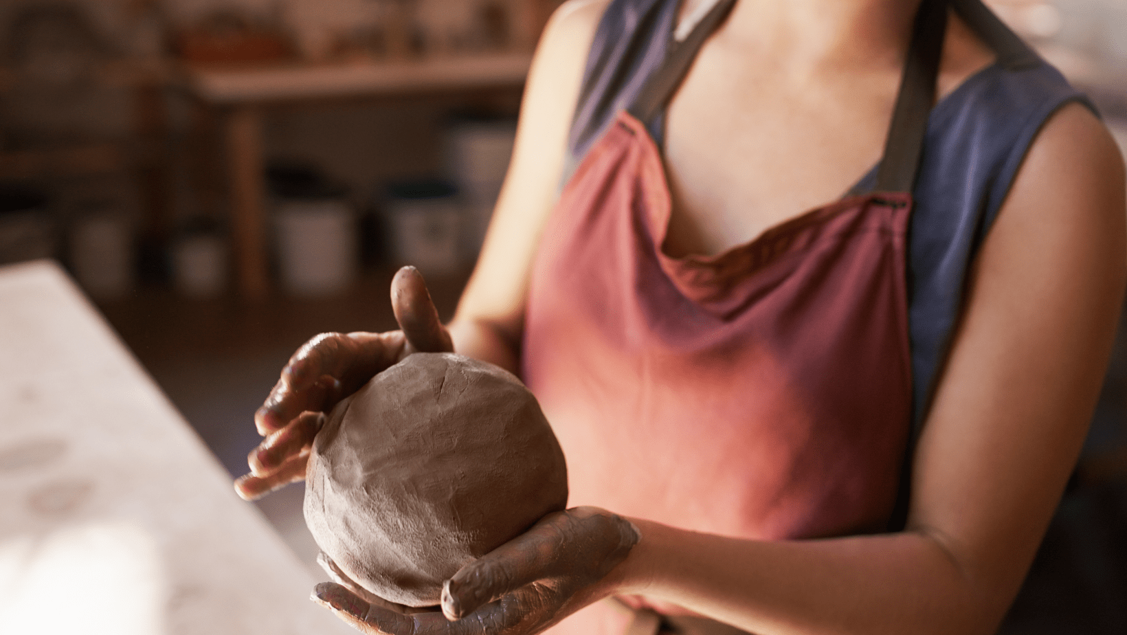 potter working with clay