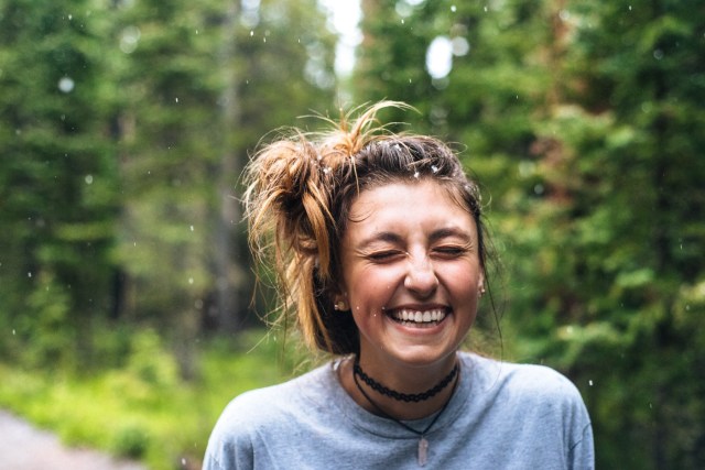 A person smiling outside Description automatically generated with low confidence