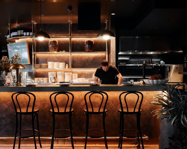 A person behind a bar

Description automatically generated with medium confidence
