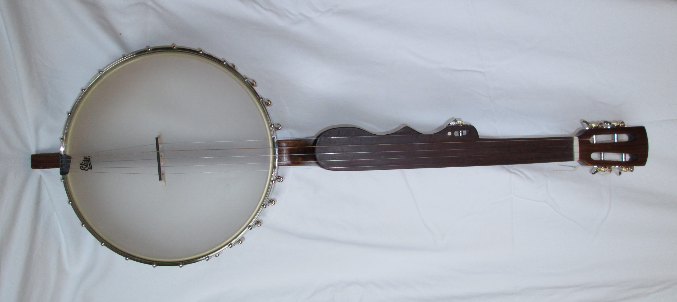 A five string banjo with a sculpted bass side of the neck