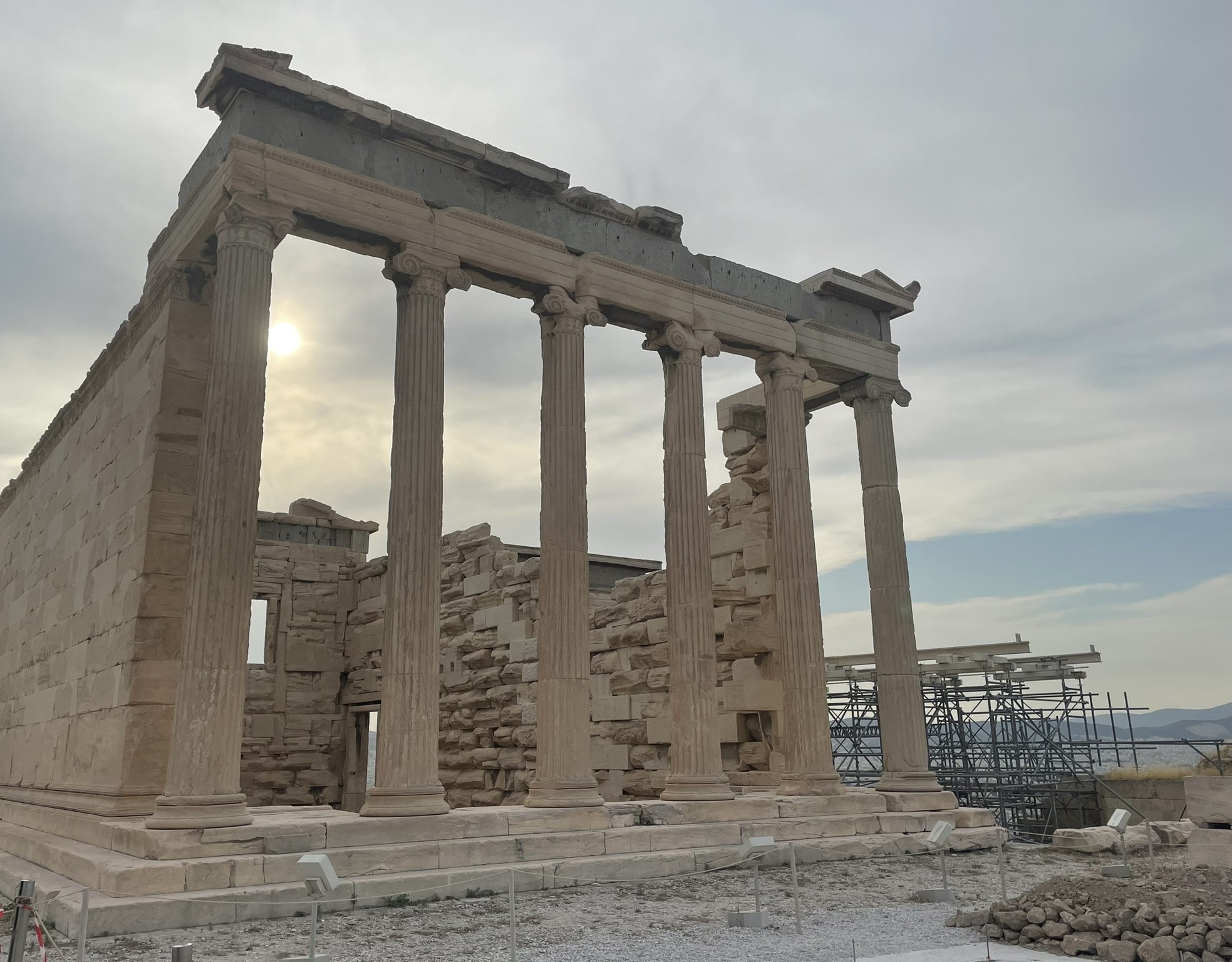 stone columns of the Parthenon, with scaffolding in the background