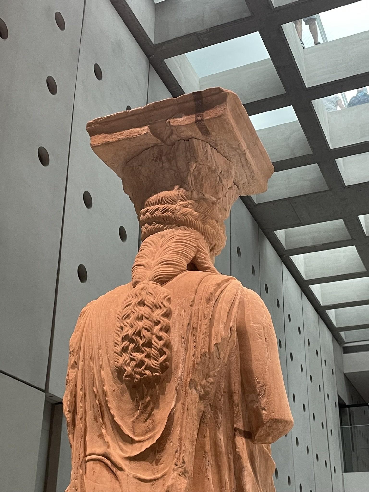 back of statue, showing elaborate braided and curled hairstyle