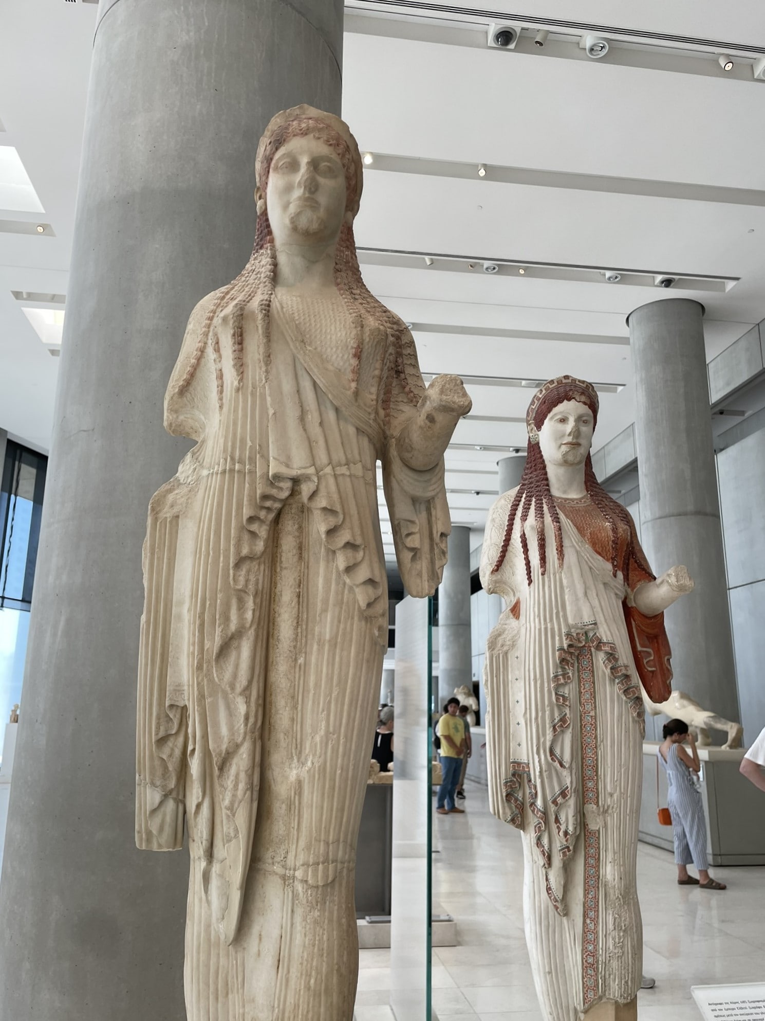 two female statues in a museum