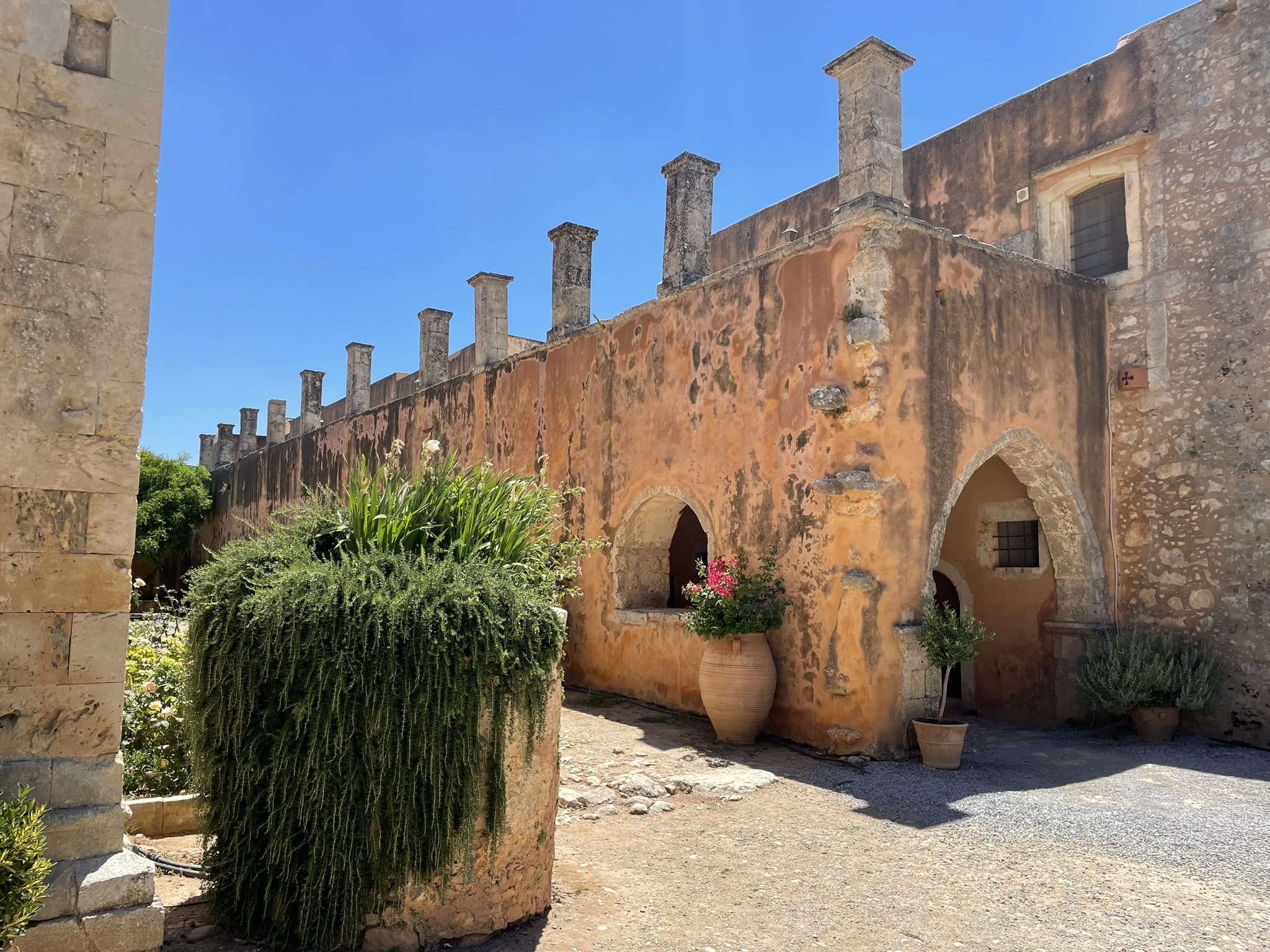 two story stone building with long outdoor arcade