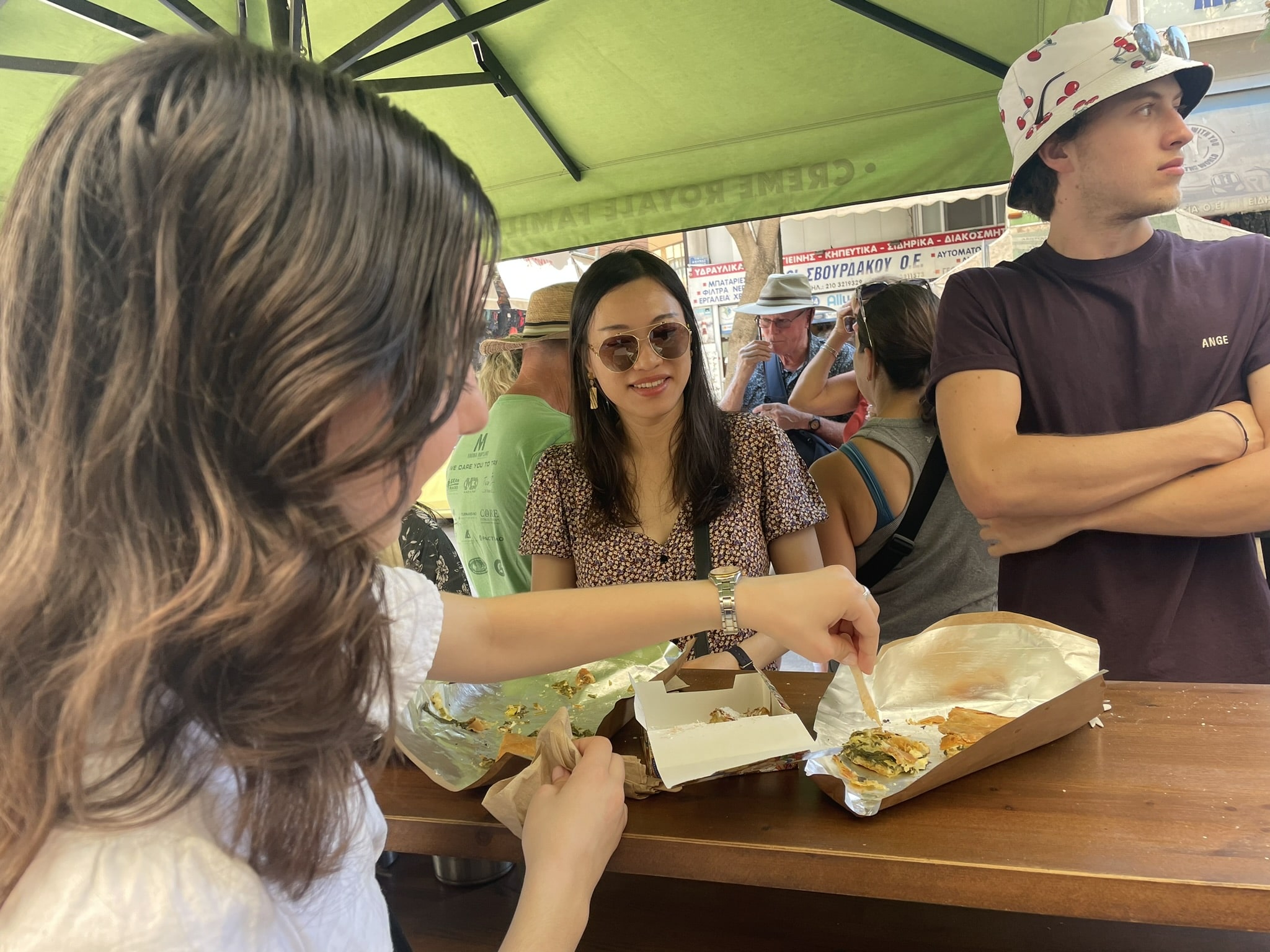 girl seen from back poking a fork into a flakey pastry