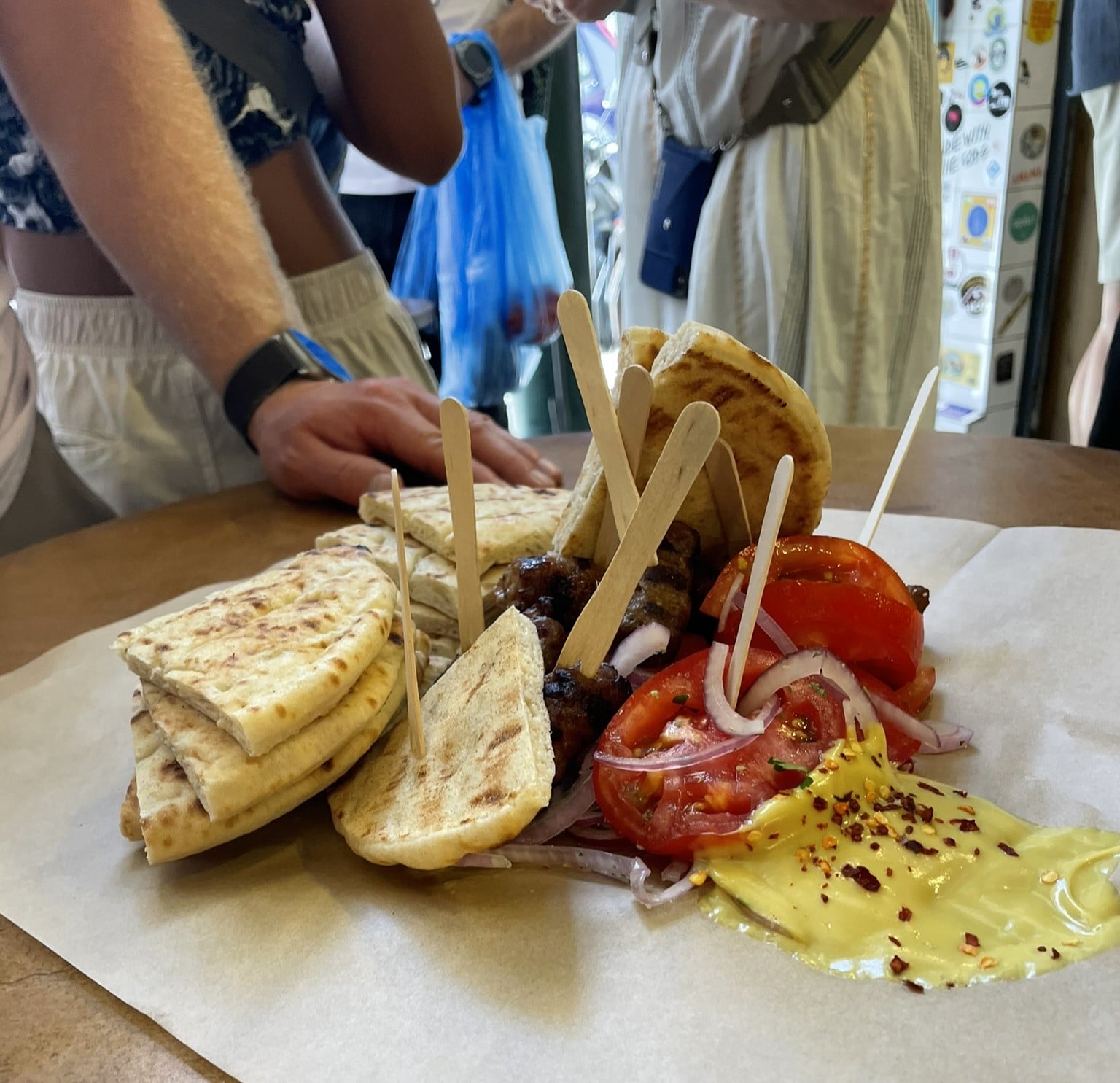 pita bread, mustard, tomatoes, onions, and grilled meat