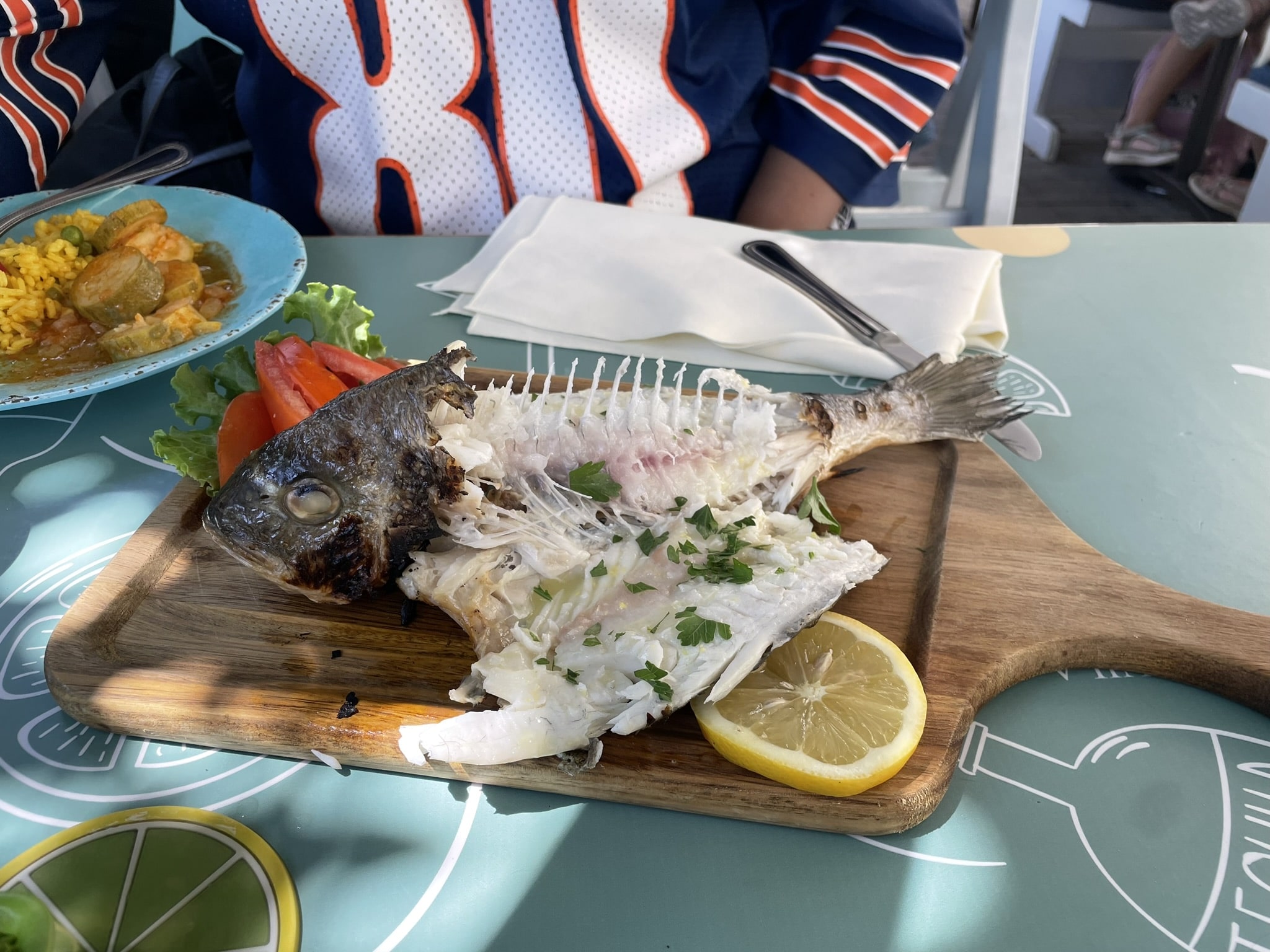 whole grilled fish served on a wooden board
