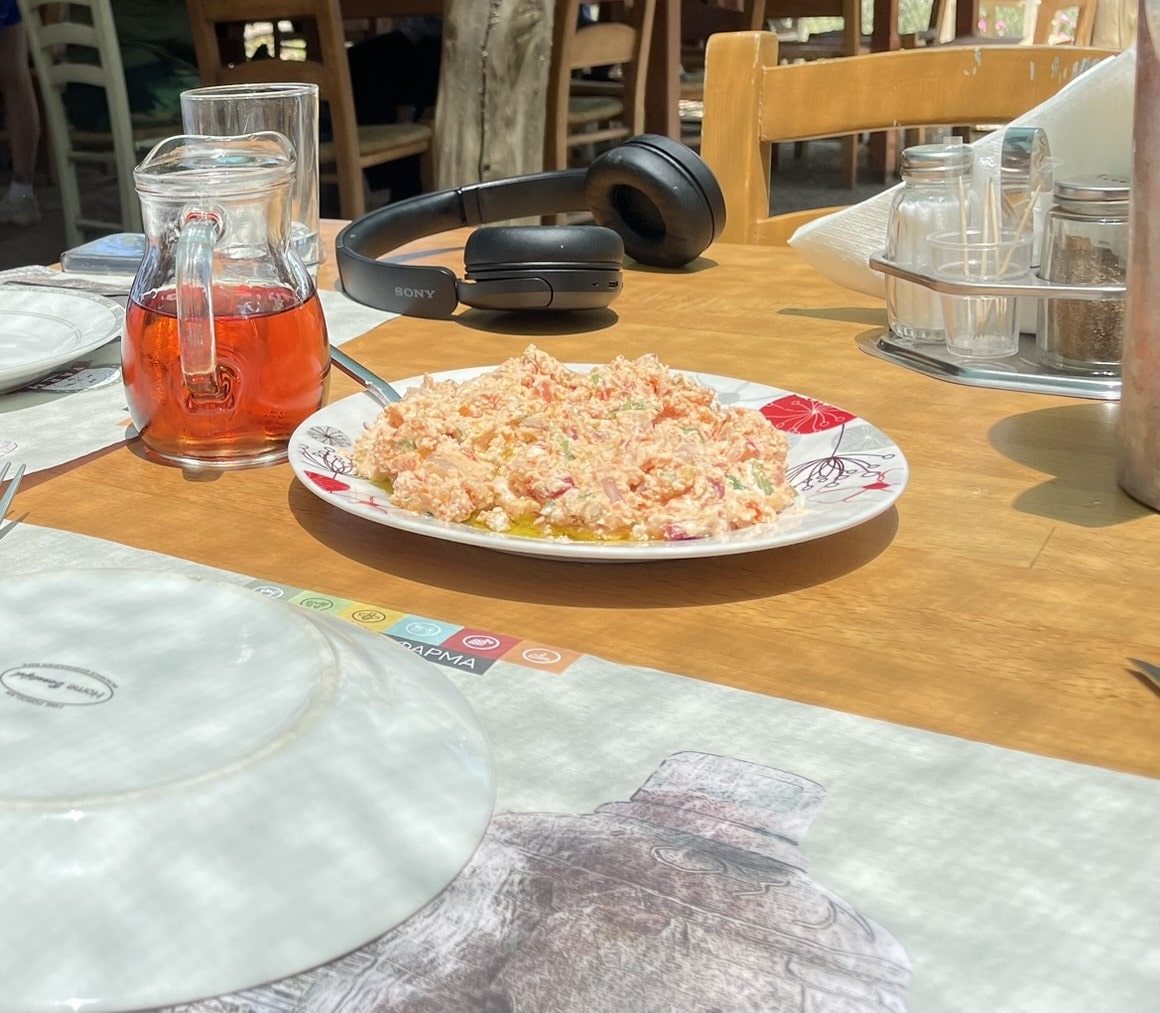 pitcher of wine next to a plate of cheese dip