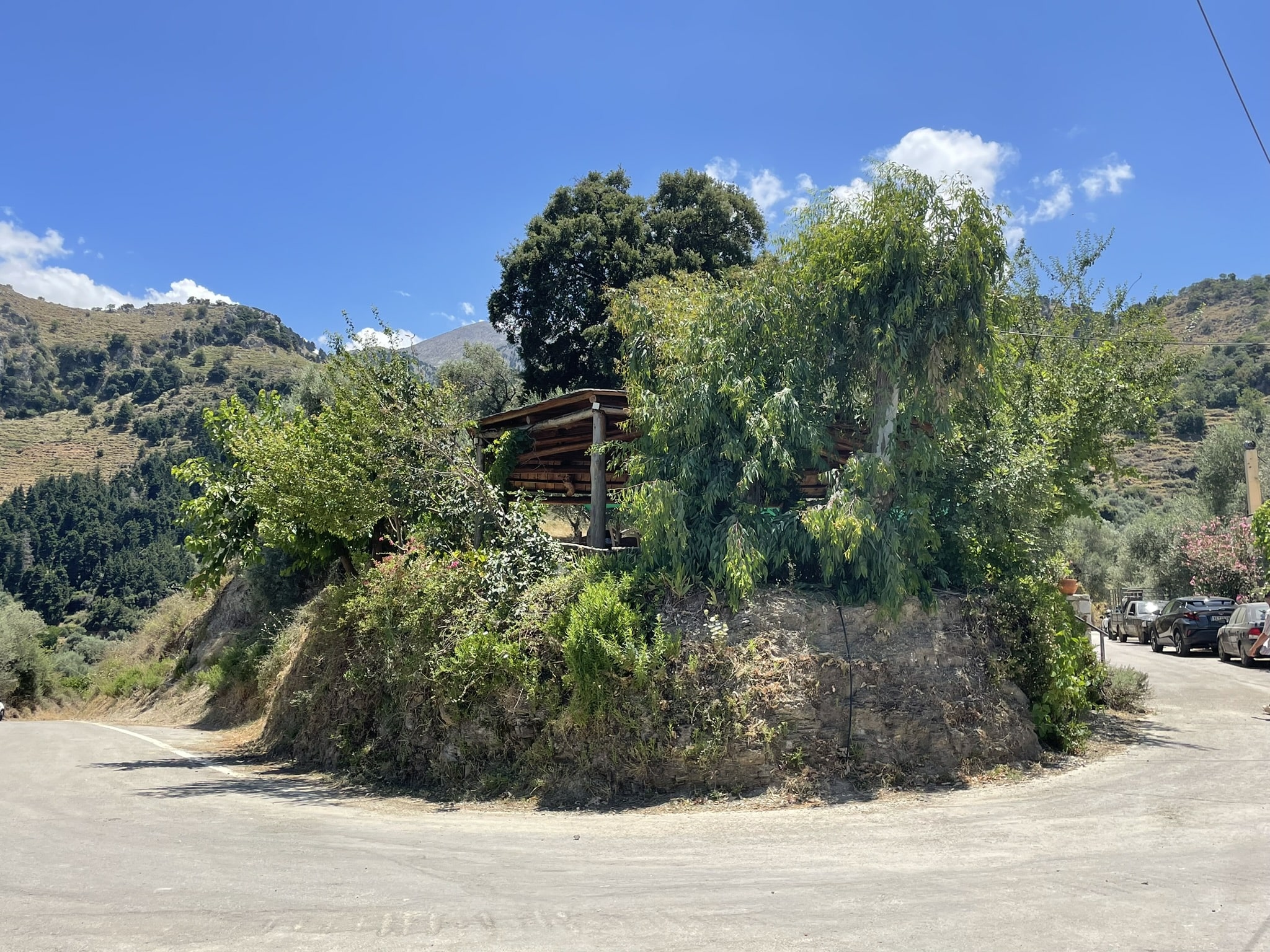 raised outdoor patio set above the hairpin turn of a mountain road.