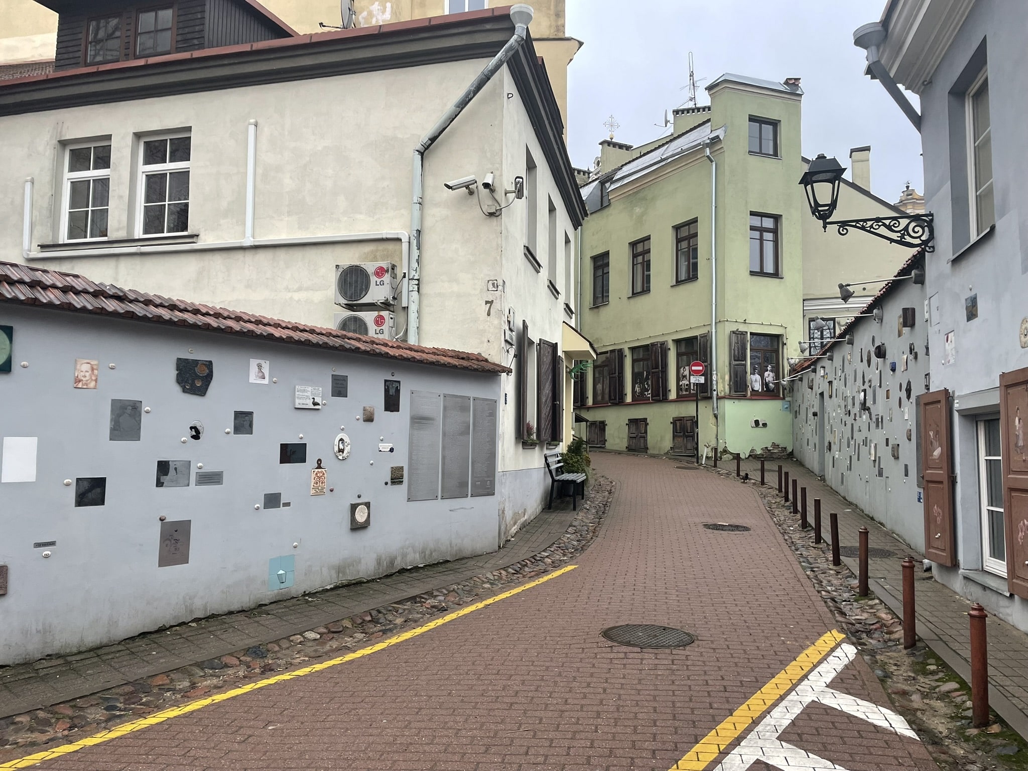 Street running between two cement walls decorated with square tiles