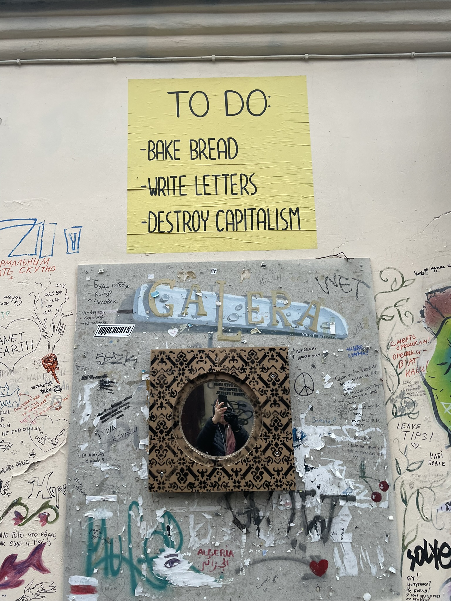 Sign reads TO DO: Bake Bread, Write Letters, Destroy Capitalism