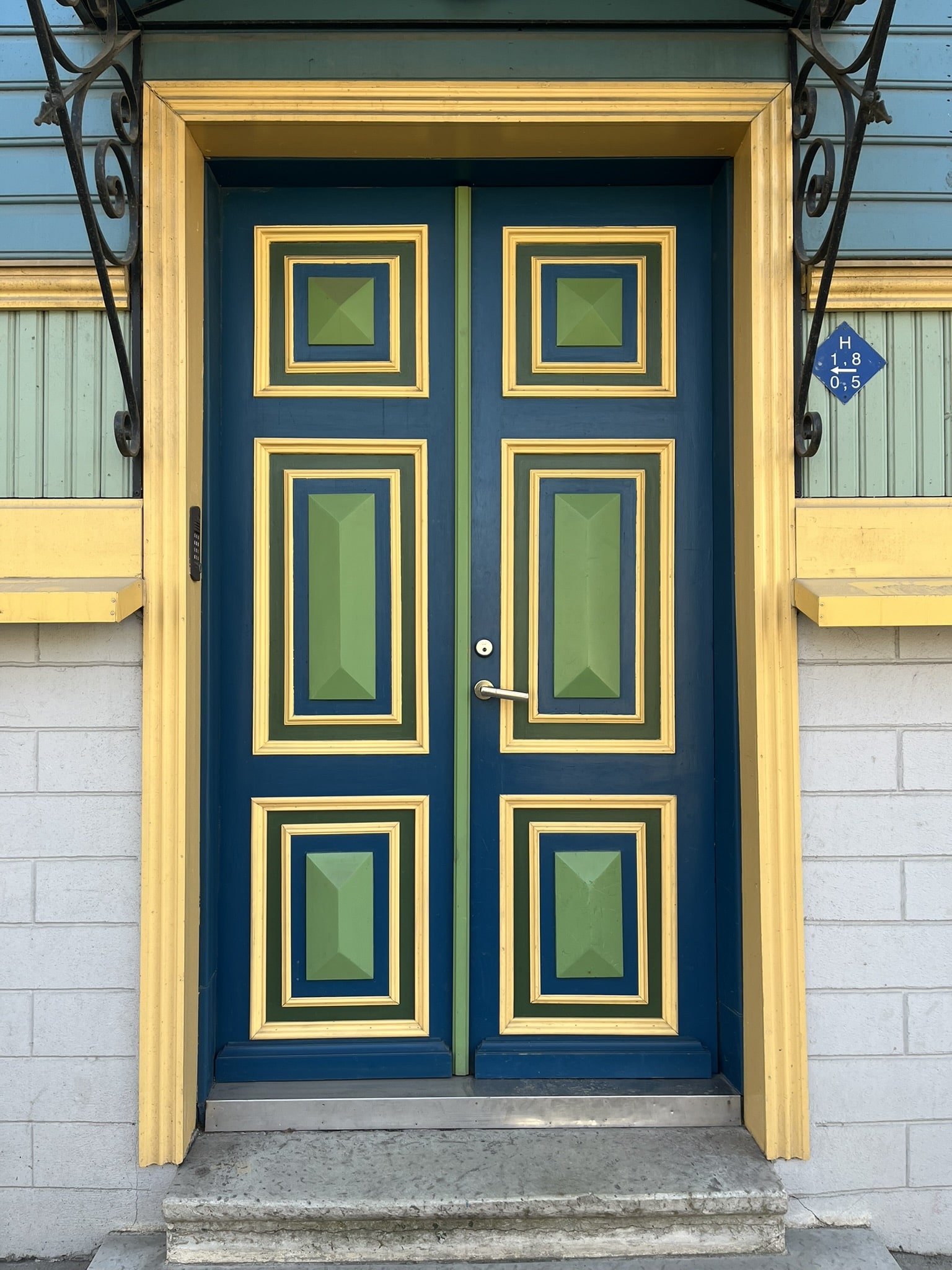 bright doorway in blue and green with yellow trim