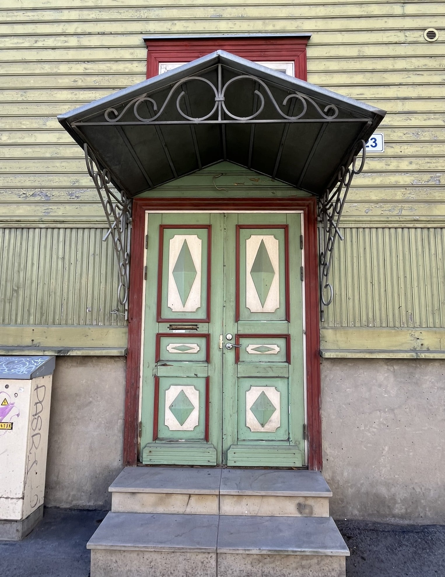 Light green doorway with white and red trim