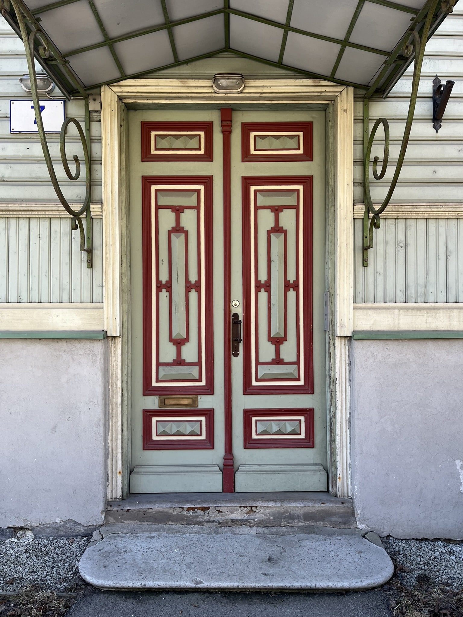 Doorway in pale green with red trim