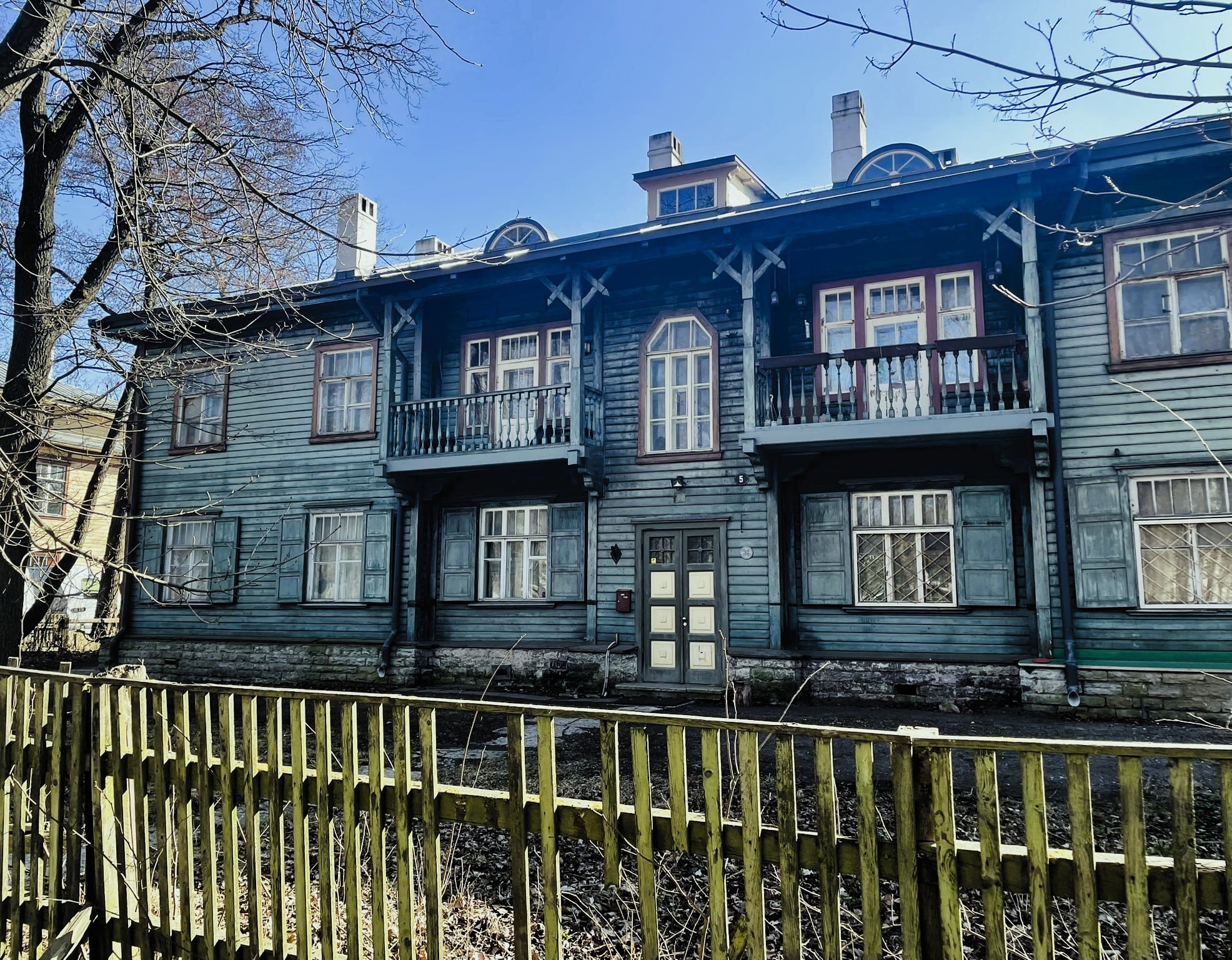 Two story wooden building with two front balconies