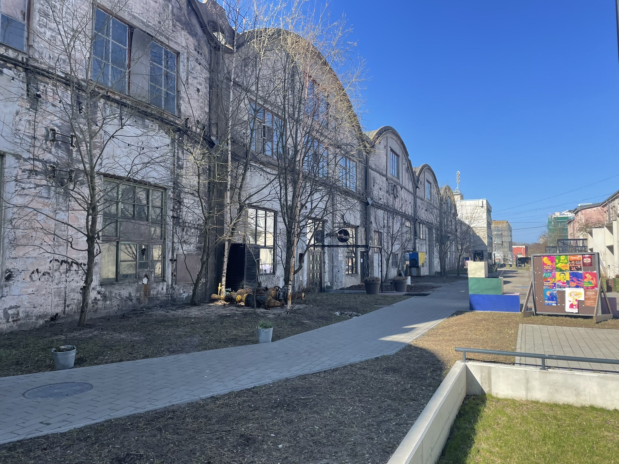 exterior view of multiple adjoining curved roof factory or warehouse buildings