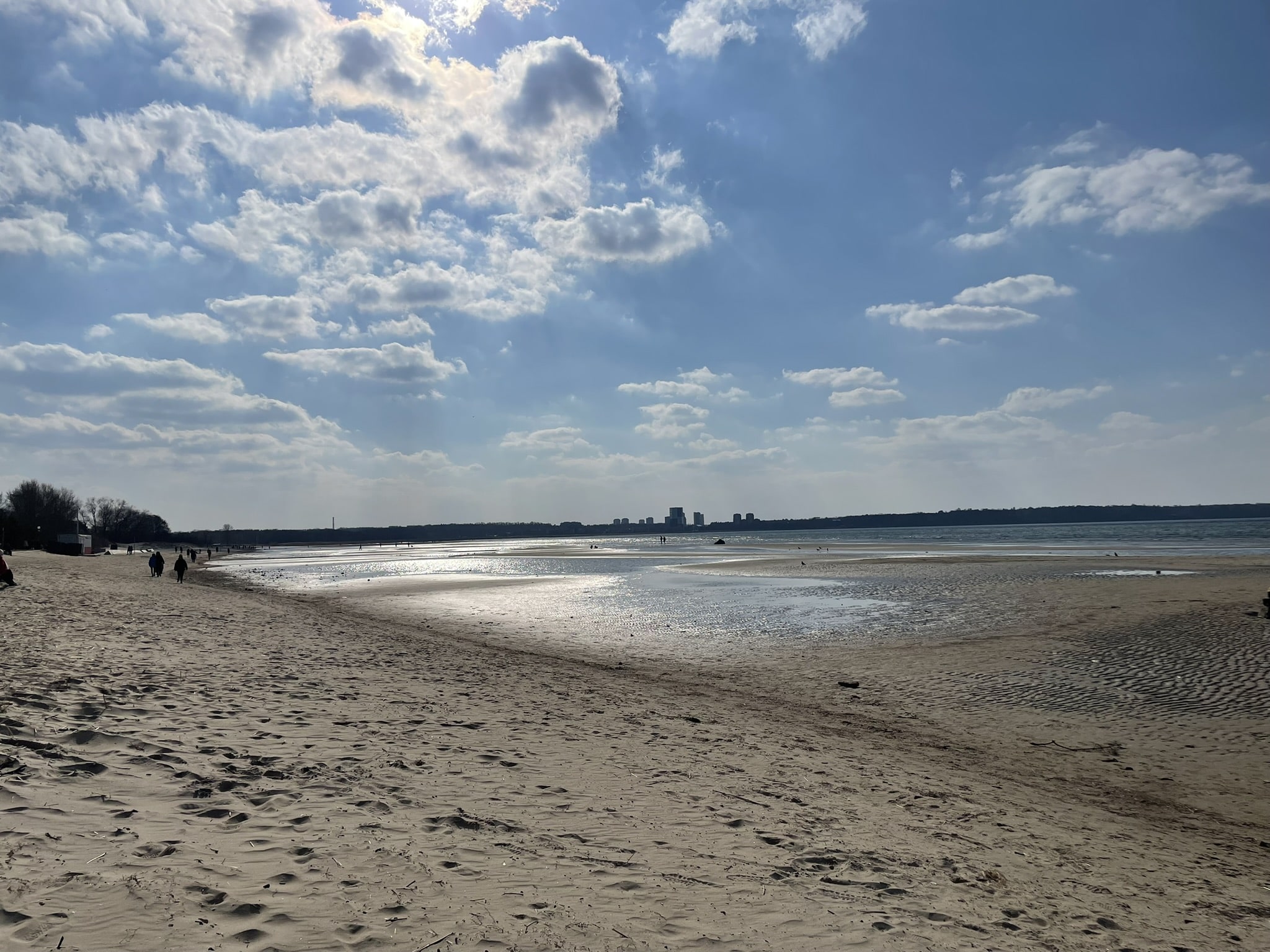 beach scene with tall buildings in the distance
